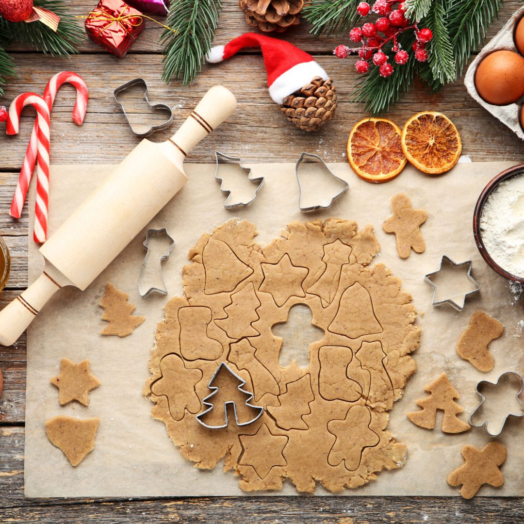 Baking christmas cookies on grey wooden table