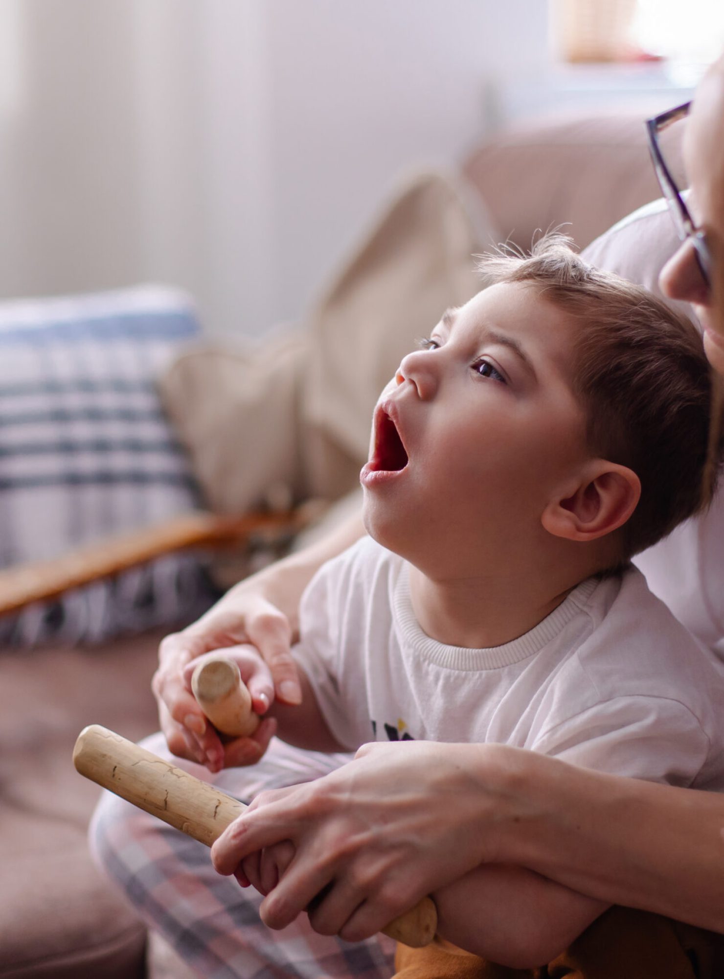 Happy family with a child with cerebral palsy. The mother and he